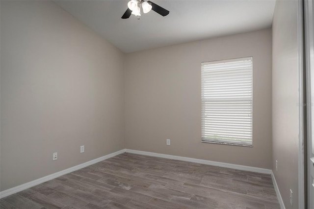 empty room with light wood-type flooring, ceiling fan, and a healthy amount of sunlight