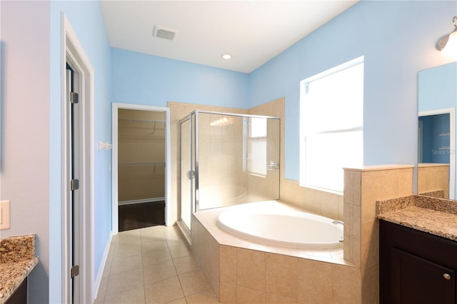 bathroom with tile patterned flooring, vanity, and shower with separate bathtub