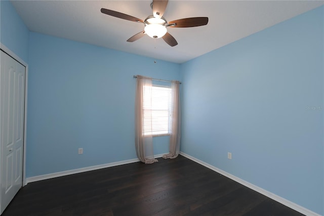 spare room featuring ceiling fan and dark hardwood / wood-style flooring