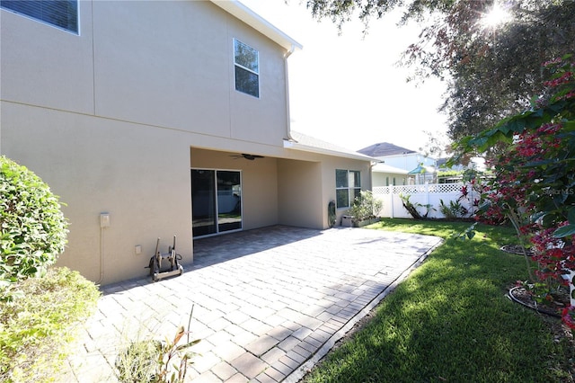 back of house with a yard and a patio area