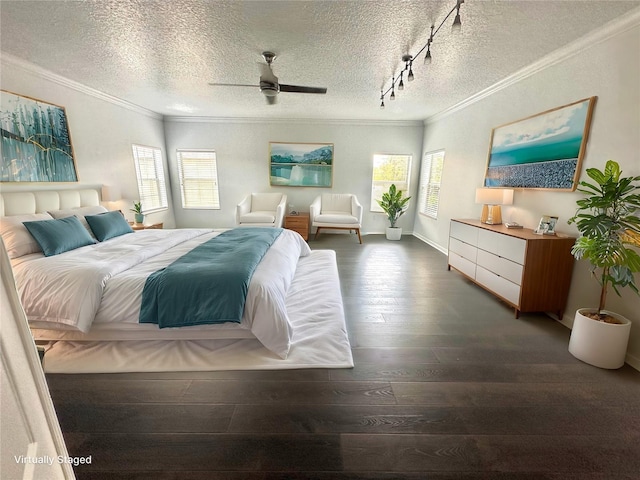 bedroom featuring dark wood-type flooring, track lighting, crown molding, ceiling fan, and a textured ceiling