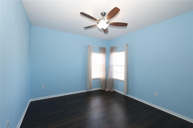 unfurnished room featuring a textured ceiling, ceiling fan, and dark wood-type flooring