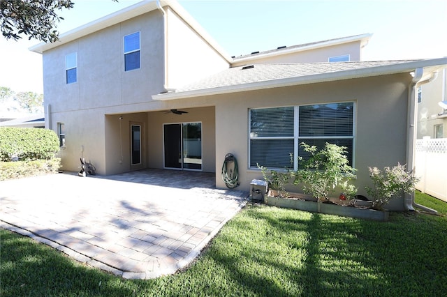 back of property featuring a patio, ceiling fan, and a lawn