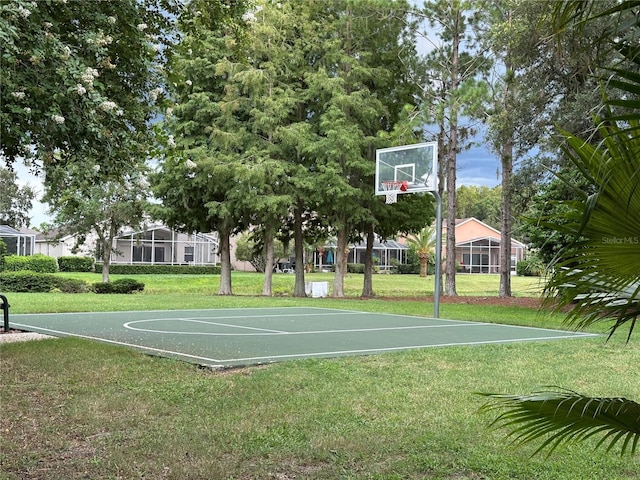 view of sport court with a yard