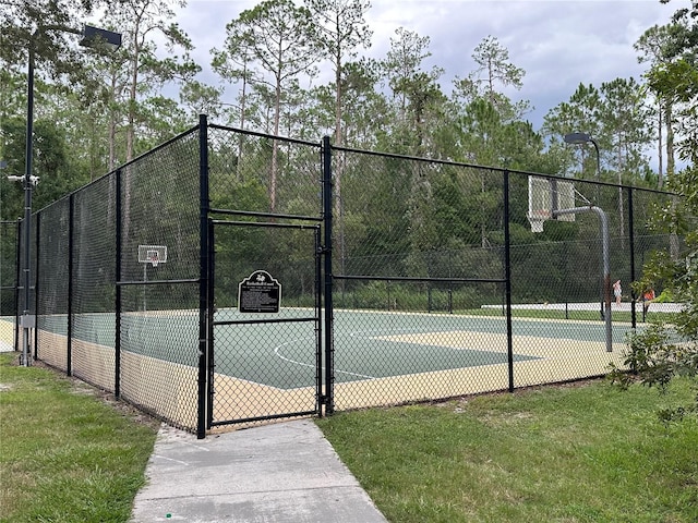 view of sport court with a yard