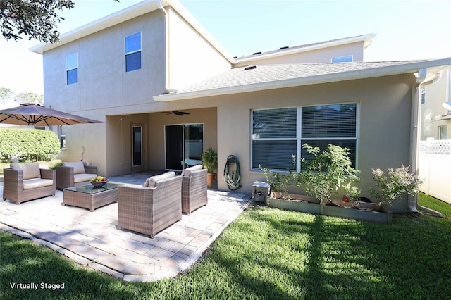 back of house with a lawn, an outdoor living space, ceiling fan, and a patio