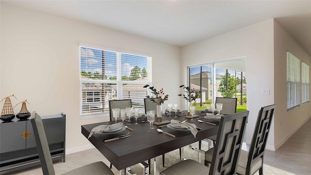 tiled dining space with a healthy amount of sunlight