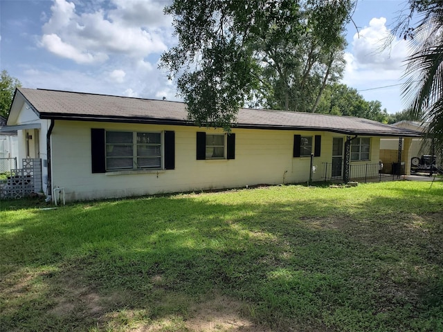 rear view of property with a lawn