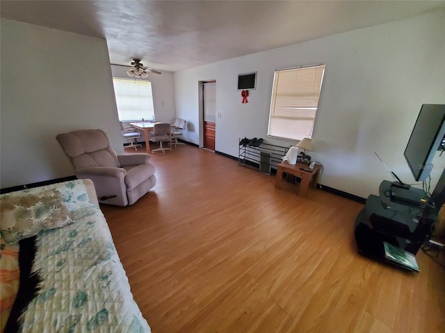 living room with hardwood / wood-style floors and ceiling fan