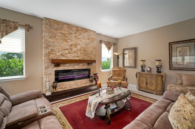 living room featuring a stone fireplace and hardwood / wood-style flooring