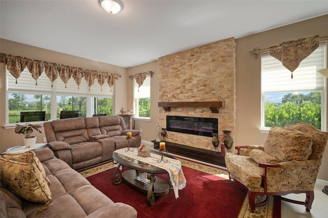 living room featuring a stone fireplace