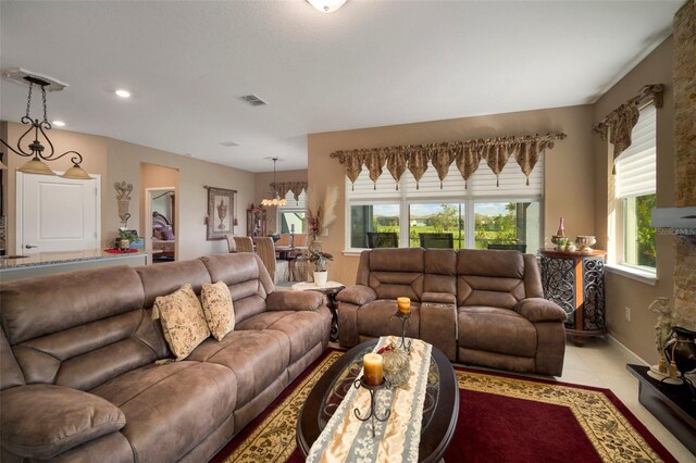 living room featuring an inviting chandelier and light tile patterned floors