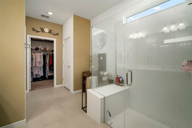 bathroom with tile patterned flooring and a shower with shower door