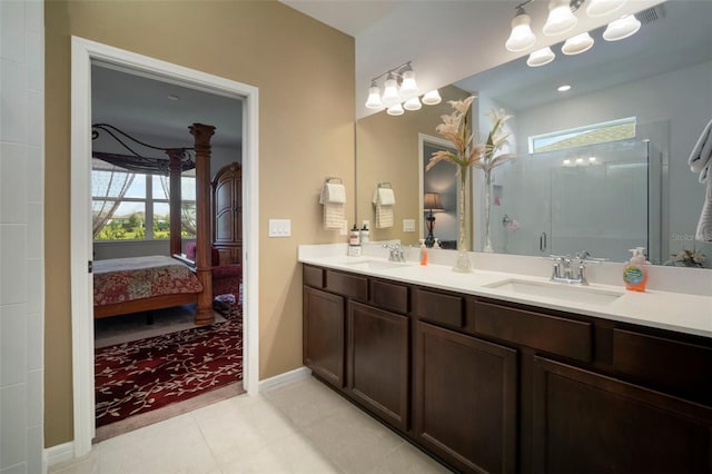 bathroom with a shower with shower door, tile patterned floors, and double sink vanity