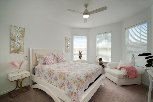 carpeted bedroom with multiple windows and ceiling fan