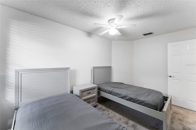 bedroom featuring carpet, a textured ceiling, and ceiling fan