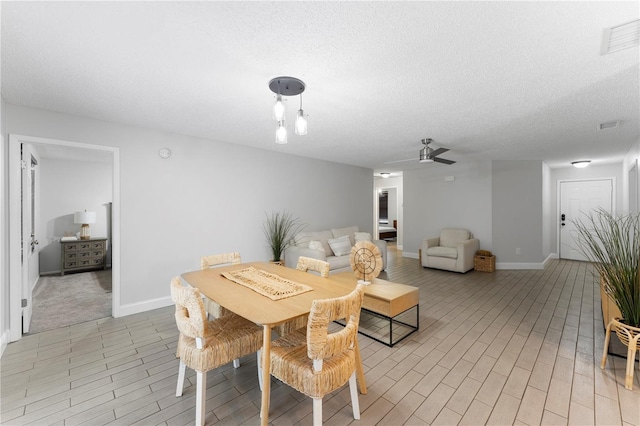 dining room featuring a textured ceiling and ceiling fan