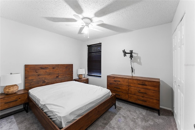 bedroom featuring a closet, ceiling fan, a textured ceiling, and light colored carpet