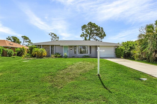 single story home featuring a garage and a front yard