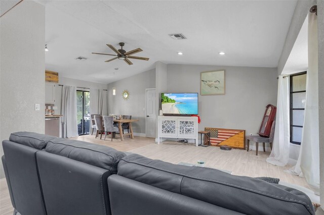 living room featuring vaulted ceiling and light wood-type flooring