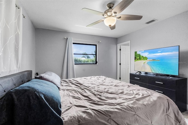 bedroom with a textured ceiling and ceiling fan