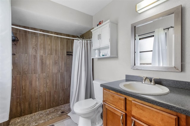 bathroom with tile patterned flooring, curtained shower, toilet, and vanity