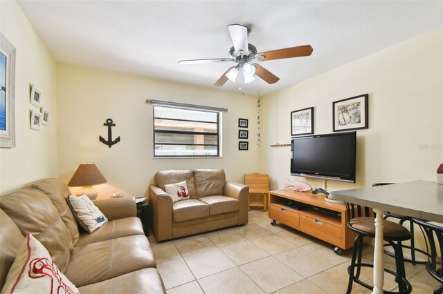 tiled living room featuring ceiling fan