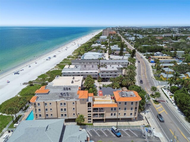 drone / aerial view featuring a water view and a view of the beach