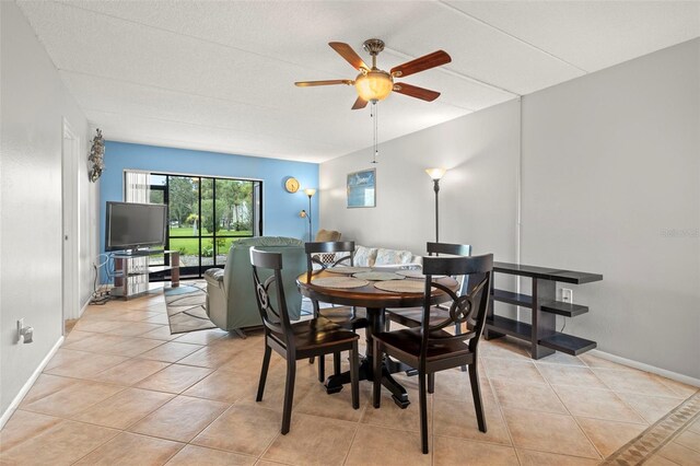 dining area featuring light tile patterned floors and ceiling fan