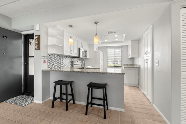 kitchen with open shelves, stainless steel appliances, visible vents, white cabinets, and a peninsula