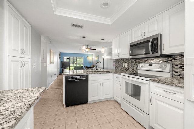 kitchen featuring black dishwasher, stainless steel microwave, a peninsula, a tray ceiling, and white electric range