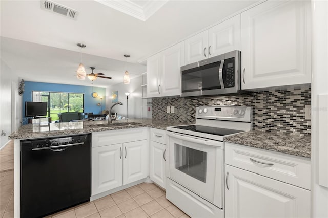 kitchen featuring black dishwasher, white electric stove, white cabinets, stainless steel microwave, and a peninsula