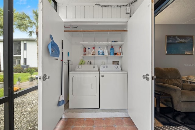 laundry room featuring light tile patterned flooring, plenty of natural light, and separate washer and dryer