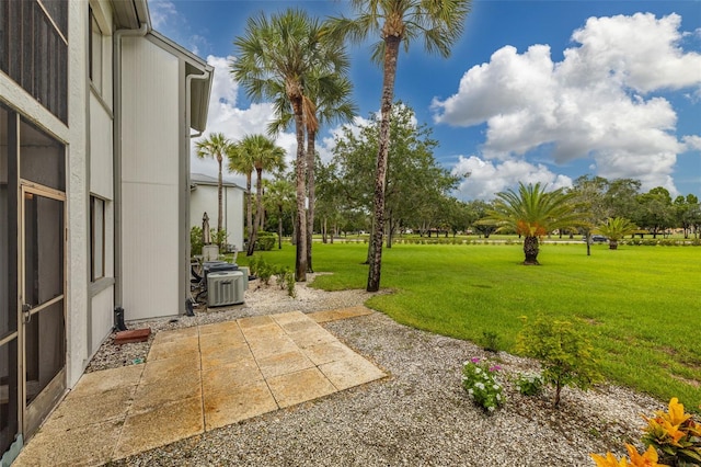 view of yard with cooling unit and a patio