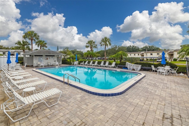 pool with fence and a patio