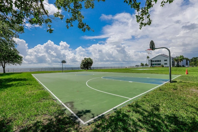 view of sport court featuring a yard