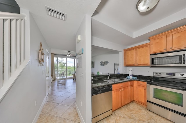 kitchen featuring ceiling fan, light tile patterned floors, sink, and appliances with stainless steel finishes