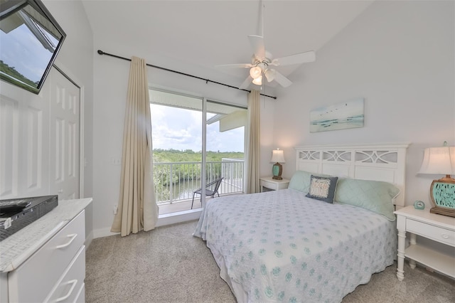bedroom with access to outside, ceiling fan, light colored carpet, and a water view