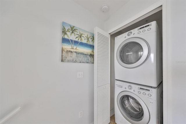 laundry area with stacked washer and clothes dryer