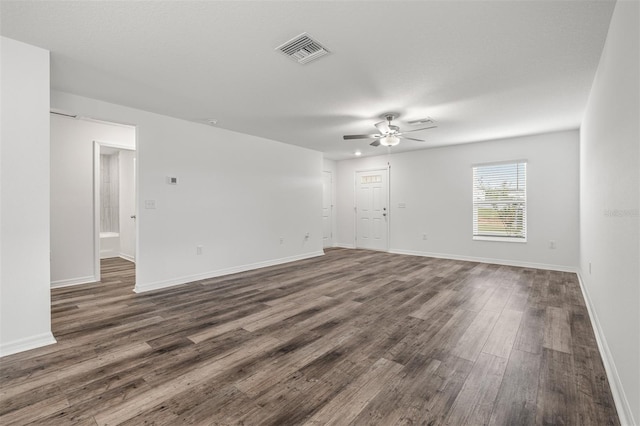 spare room featuring dark hardwood / wood-style flooring and ceiling fan