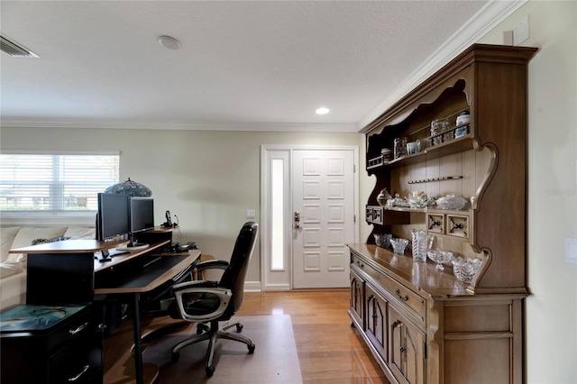 office featuring visible vents, light wood-style flooring, and crown molding