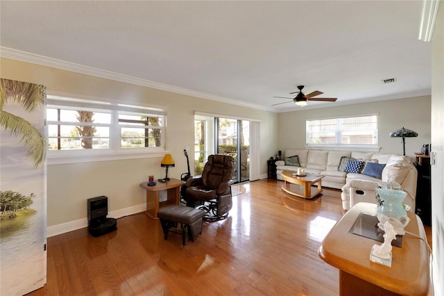 living room with plenty of natural light, ceiling fan, and hardwood / wood-style flooring