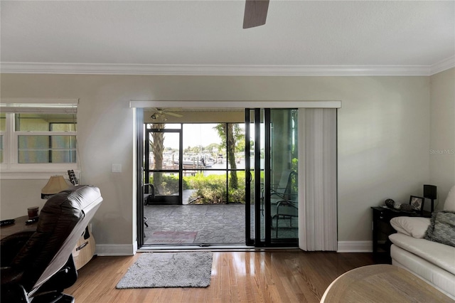 doorway to outside with ceiling fan, hardwood / wood-style floors, and ornamental molding