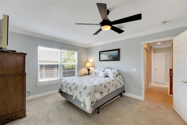 carpeted bedroom with ceiling fan and ornamental molding