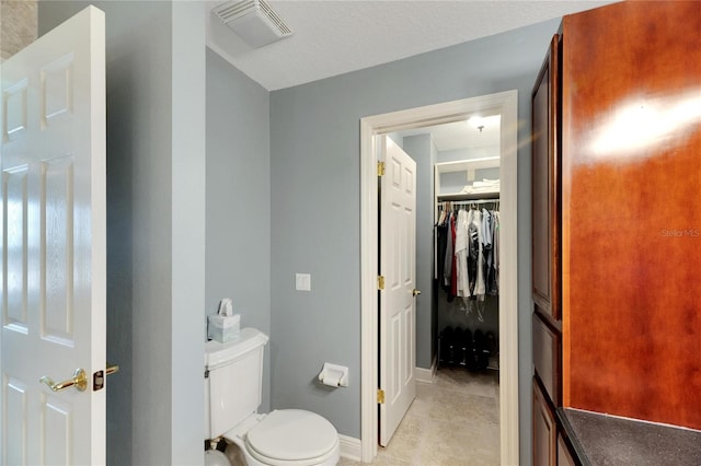 bathroom with tile patterned flooring and toilet