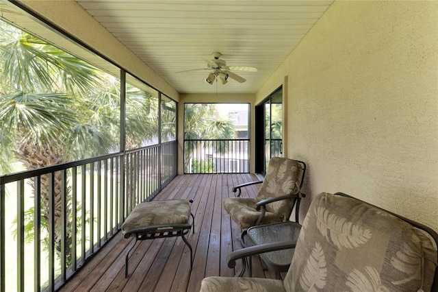 wooden terrace featuring a ceiling fan