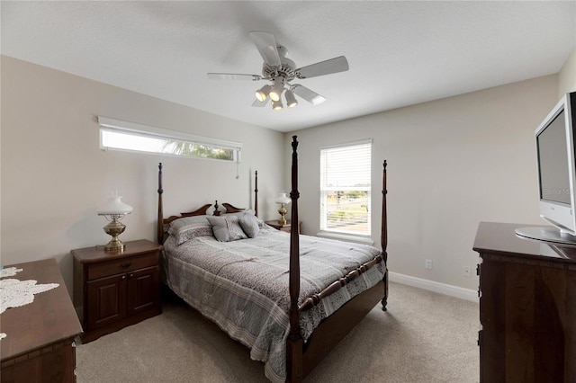 bedroom with baseboards, a ceiling fan, and light colored carpet