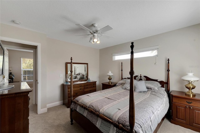 bedroom with baseboards, ceiling fan, and light colored carpet