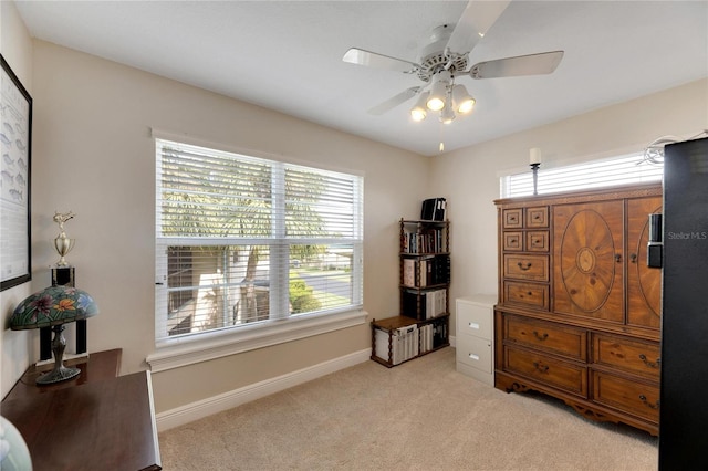 living area featuring ceiling fan and light carpet