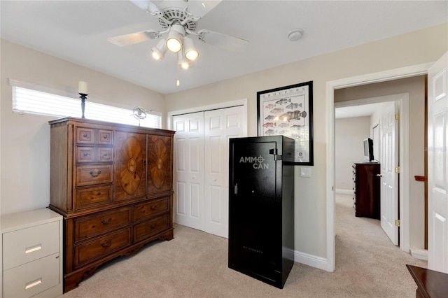 bedroom featuring ceiling fan, light carpet, and a closet